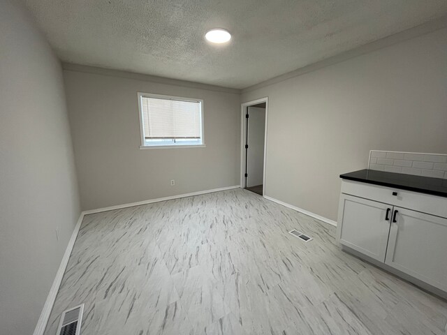 empty room with a textured ceiling