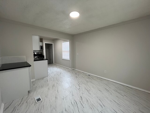 interior space with a textured ceiling