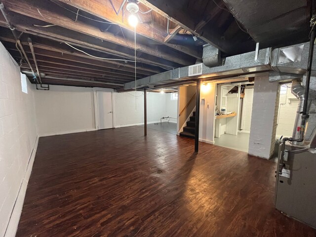 basement with hardwood / wood-style floors