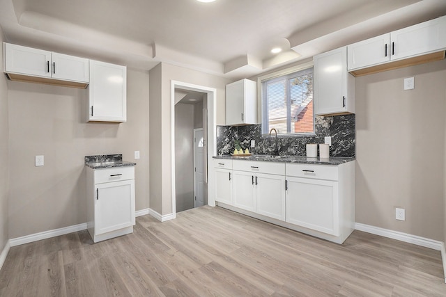 kitchen featuring sink, white cabinets, and light wood-type flooring