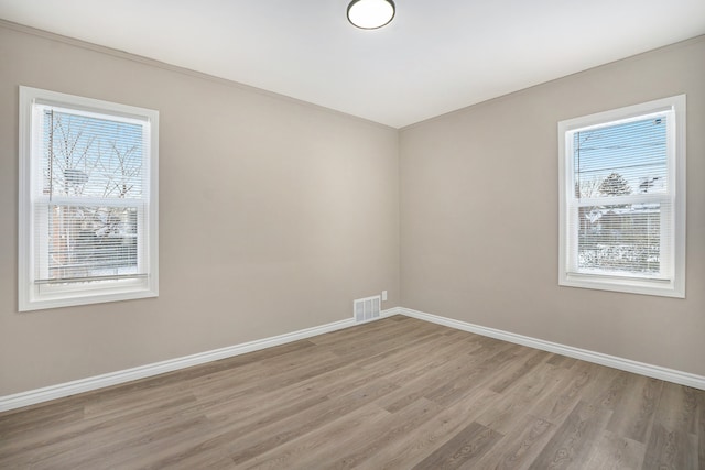 unfurnished room with light hardwood / wood-style flooring and a wealth of natural light