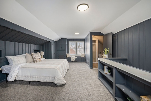 bedroom with lofted ceiling and light colored carpet