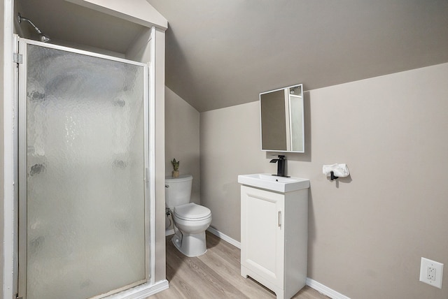 bathroom with hardwood / wood-style flooring, a shower with door, vanity, vaulted ceiling, and toilet