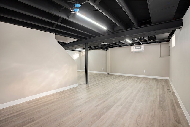 basement with hardwood / wood-style floors