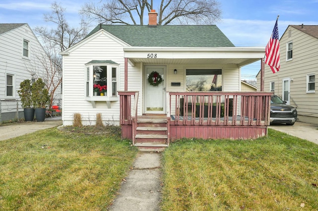 bungalow with a front lawn and a porch