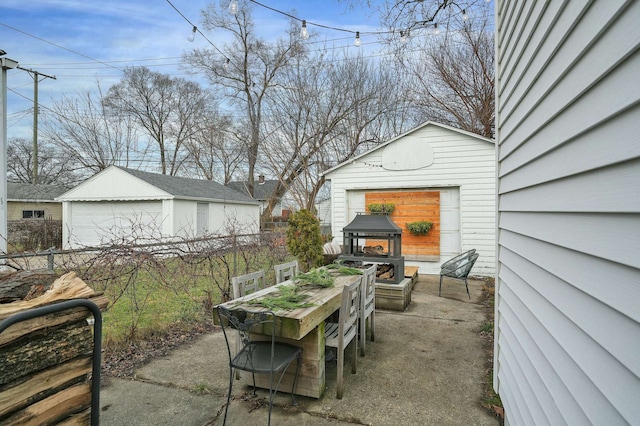 view of patio with a garage and an outdoor structure