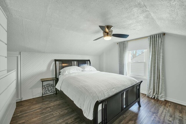 bedroom featuring lofted ceiling, dark wood-type flooring, and ceiling fan