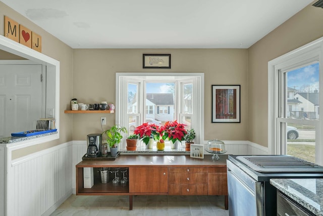 kitchen with stainless steel stove and light hardwood / wood-style flooring