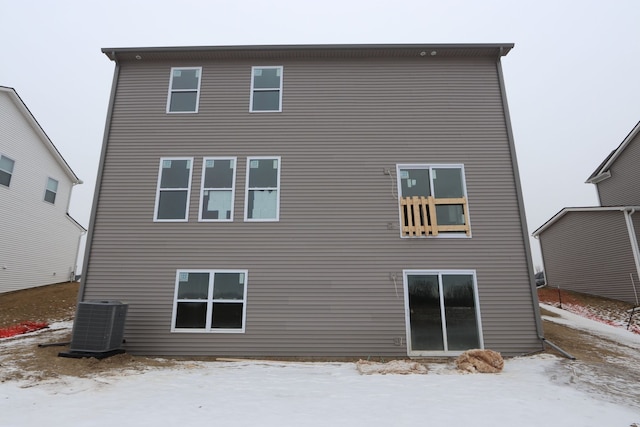 snow covered property featuring central AC