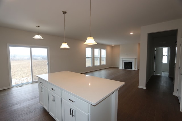 kitchen with dark wood-style floors, white cabinetry, and a center island