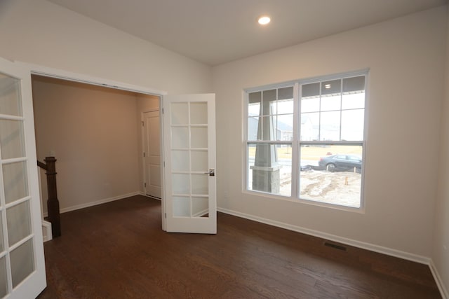 unfurnished bedroom with visible vents, dark wood-type flooring, baseboards, recessed lighting, and french doors