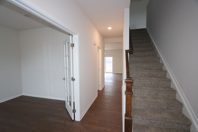 stairs with recessed lighting, wood finished floors, and baseboards