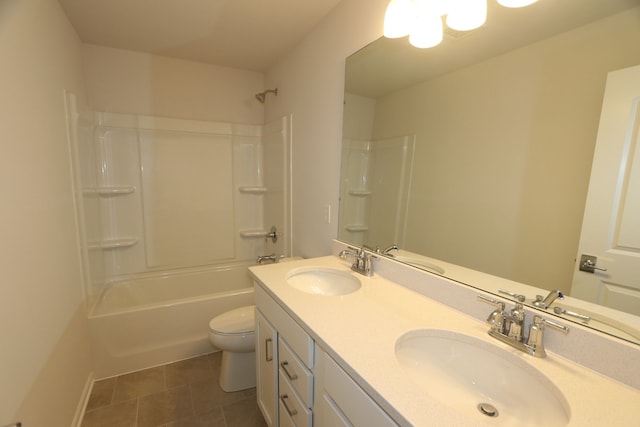 full bath with a sink, toilet, double vanity, and tile patterned floors