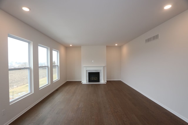 unfurnished living room featuring visible vents, recessed lighting, baseboards, and a premium fireplace