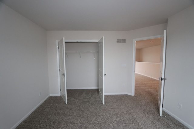 unfurnished bedroom with visible vents, baseboards, carpet floors, and a closet