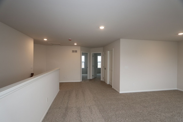 unfurnished room with recessed lighting, visible vents, and carpet floors