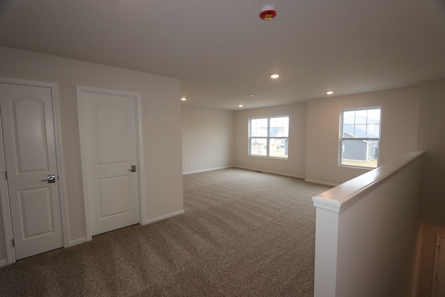 carpeted empty room with recessed lighting and baseboards