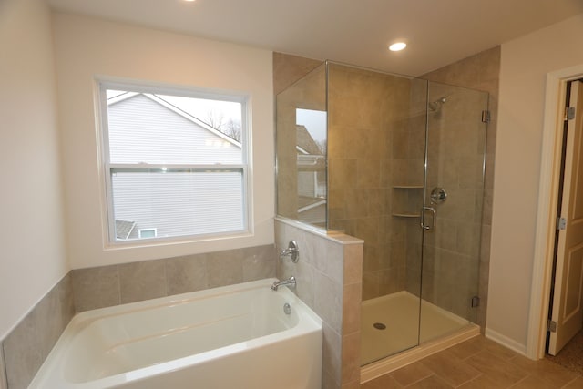 bathroom featuring recessed lighting, a garden tub, and a stall shower