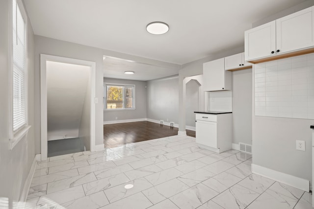 kitchen featuring white cabinetry and decorative backsplash