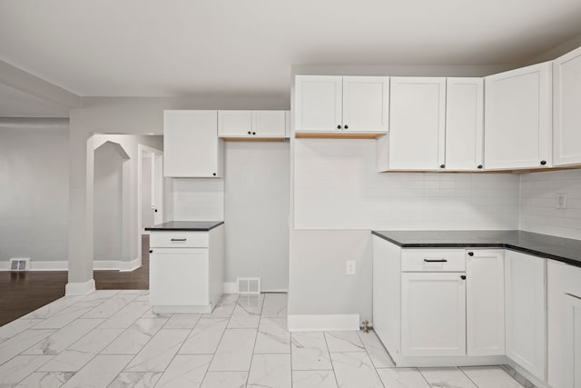 kitchen with white cabinetry and decorative backsplash