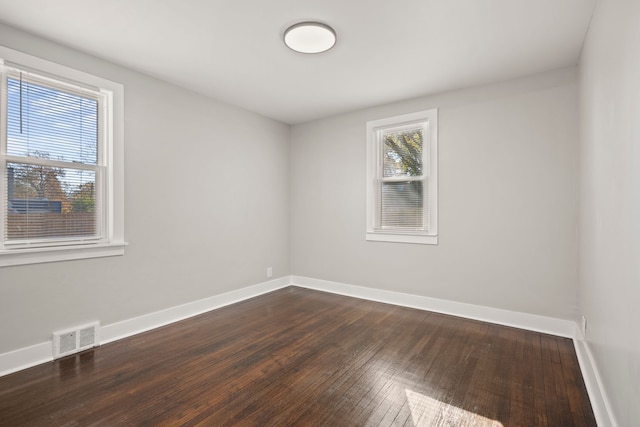 spare room featuring dark wood-type flooring