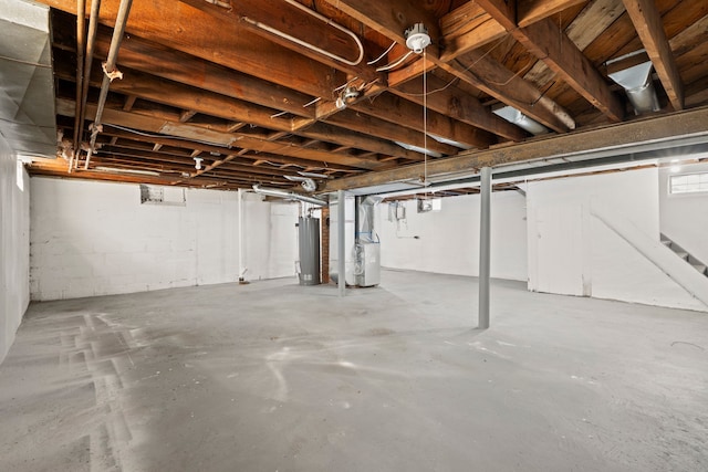 basement featuring gas water heater and heating unit