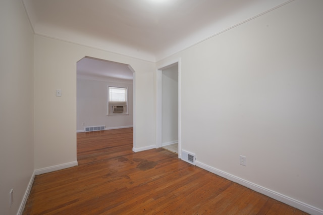 empty room with dark hardwood / wood-style flooring and cooling unit