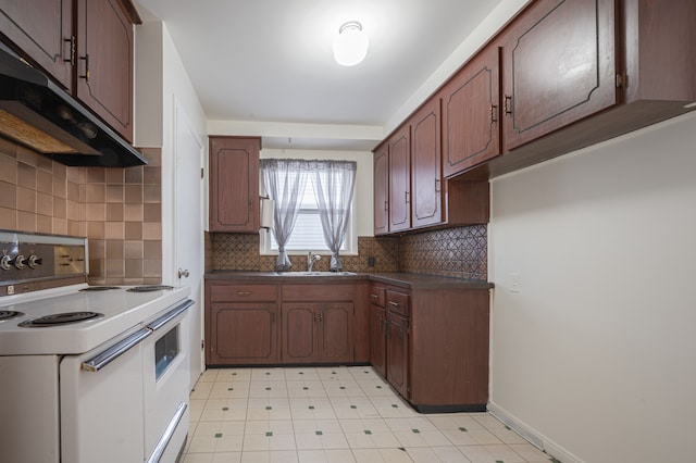 kitchen with double oven range, decorative backsplash, dark brown cabinets, and sink