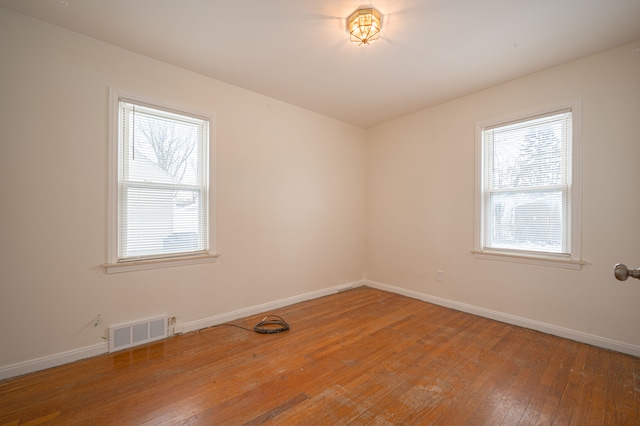 spare room with wood-type flooring