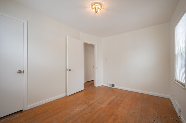 unfurnished bedroom featuring light hardwood / wood-style floors and multiple windows