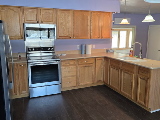 kitchen with sink, decorative light fixtures, dark hardwood / wood-style floors, kitchen peninsula, and stainless steel appliances