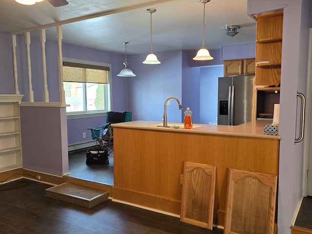 kitchen featuring dark hardwood / wood-style floors, sink, stainless steel fridge, and baseboard heating