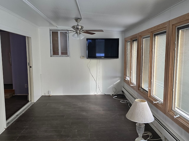 unfurnished living room featuring ornamental molding, dark hardwood / wood-style floors, ceiling fan, and a baseboard radiator