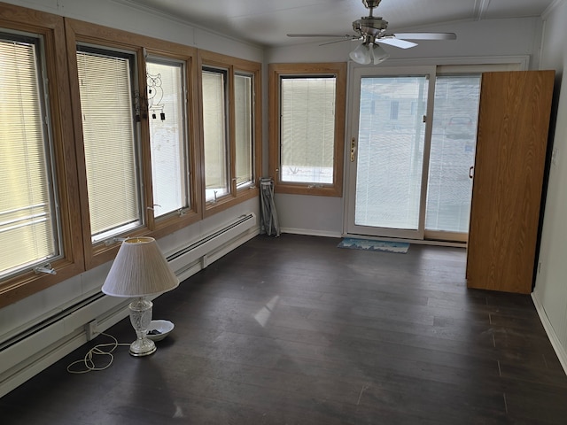 unfurnished sunroom featuring ceiling fan, a baseboard radiator, and a healthy amount of sunlight