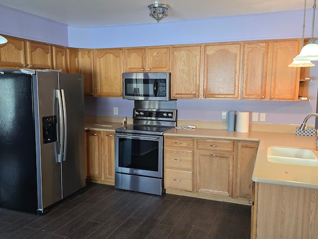 kitchen with sink, dark wood-type flooring, hanging light fixtures, stainless steel appliances, and light brown cabinets