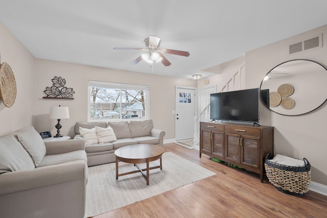 living room with ceiling fan and light wood-type flooring