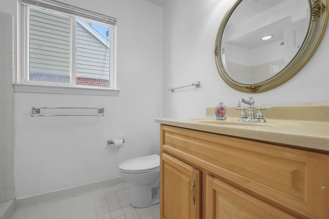 bathroom featuring vanity, tile patterned flooring, and toilet