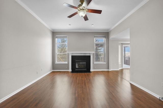 unfurnished living room featuring crown molding, dark wood-type flooring, and a tile fireplace