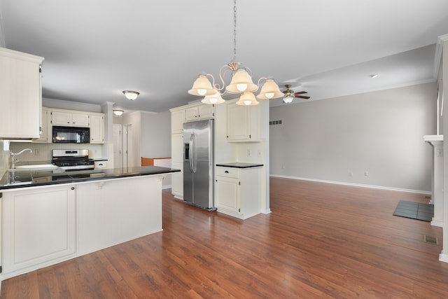 kitchen featuring sink, white cabinetry, dark hardwood / wood-style flooring, stainless steel appliances, and decorative backsplash