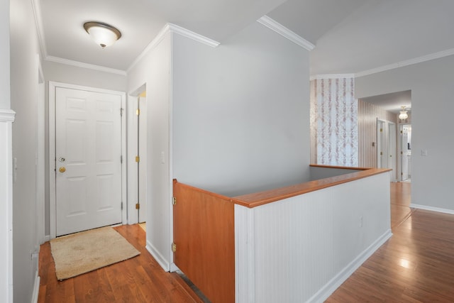 hallway with hardwood / wood-style flooring and crown molding