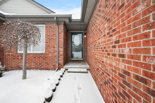 view of snow covered property entrance