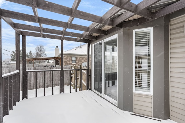 snow covered deck featuring a pergola