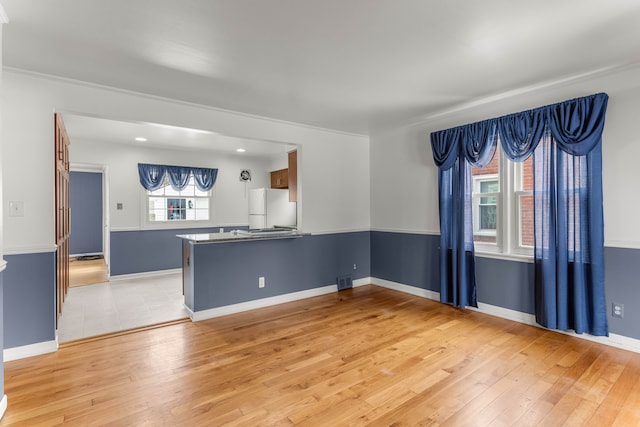 unfurnished room with light wood-type flooring