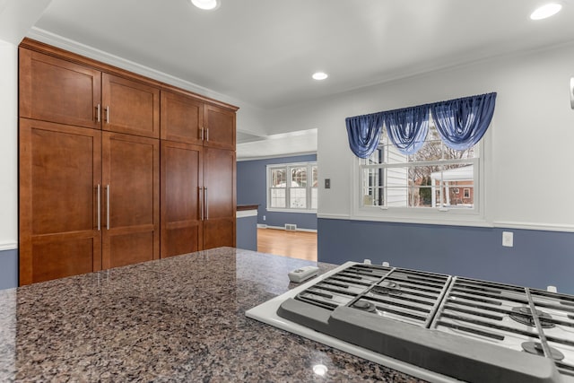 kitchen with stovetop and dark stone countertops