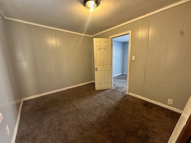 carpeted empty room featuring crown molding