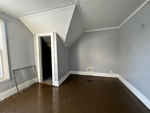 bonus room with dark wood-type flooring and vaulted ceiling