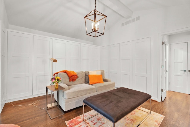 living room featuring lofted ceiling with beams, dark hardwood / wood-style floors, and a notable chandelier