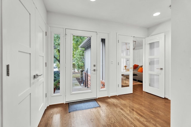 doorway with hardwood / wood-style floors and french doors