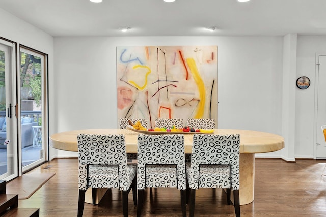 dining space featuring breakfast area and hardwood / wood-style floors