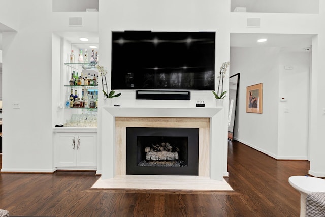 living room featuring indoor bar and dark hardwood / wood-style flooring